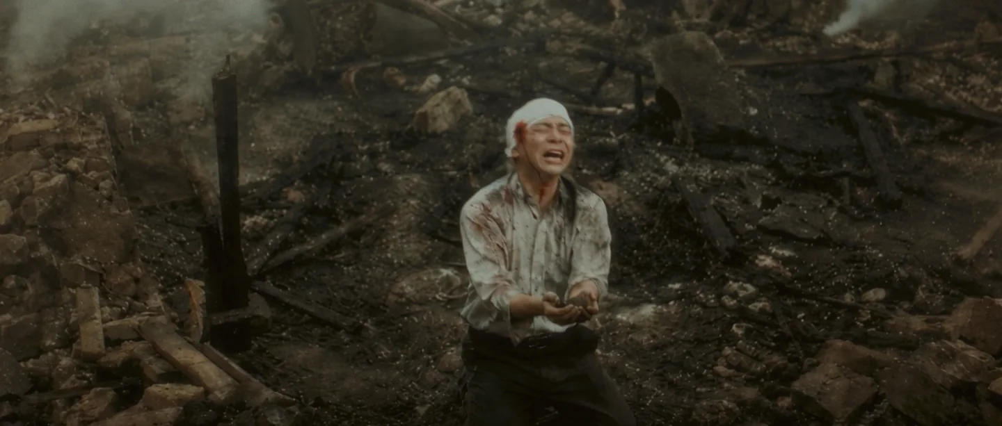 A survivor kneeling among the ruins